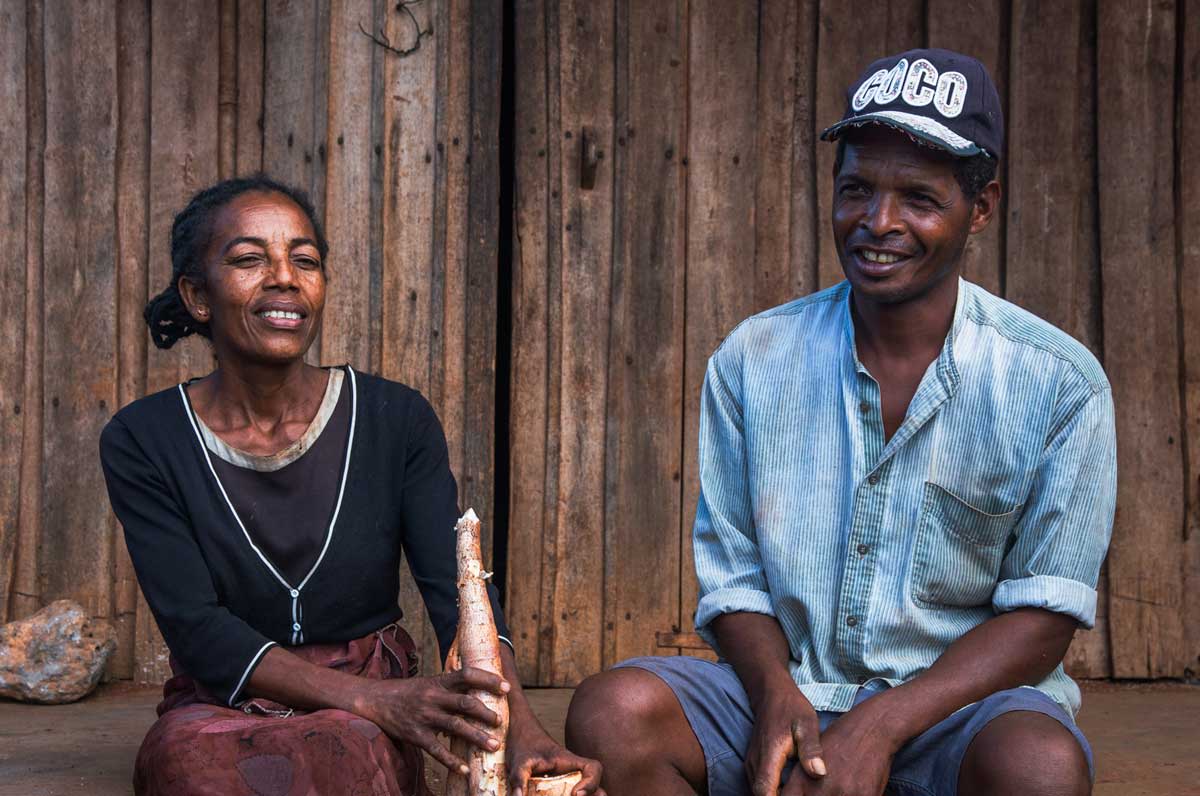 Bertin Mara and his wife with cassava they have recently harvested. Thanks to climate-smart farming techniques and seeds, they are able to grow a variety of drought-resistant crops that help feed themselves and their community year-round. (Tsiky Lalatiana Ranaivoarisoa/World Bank)