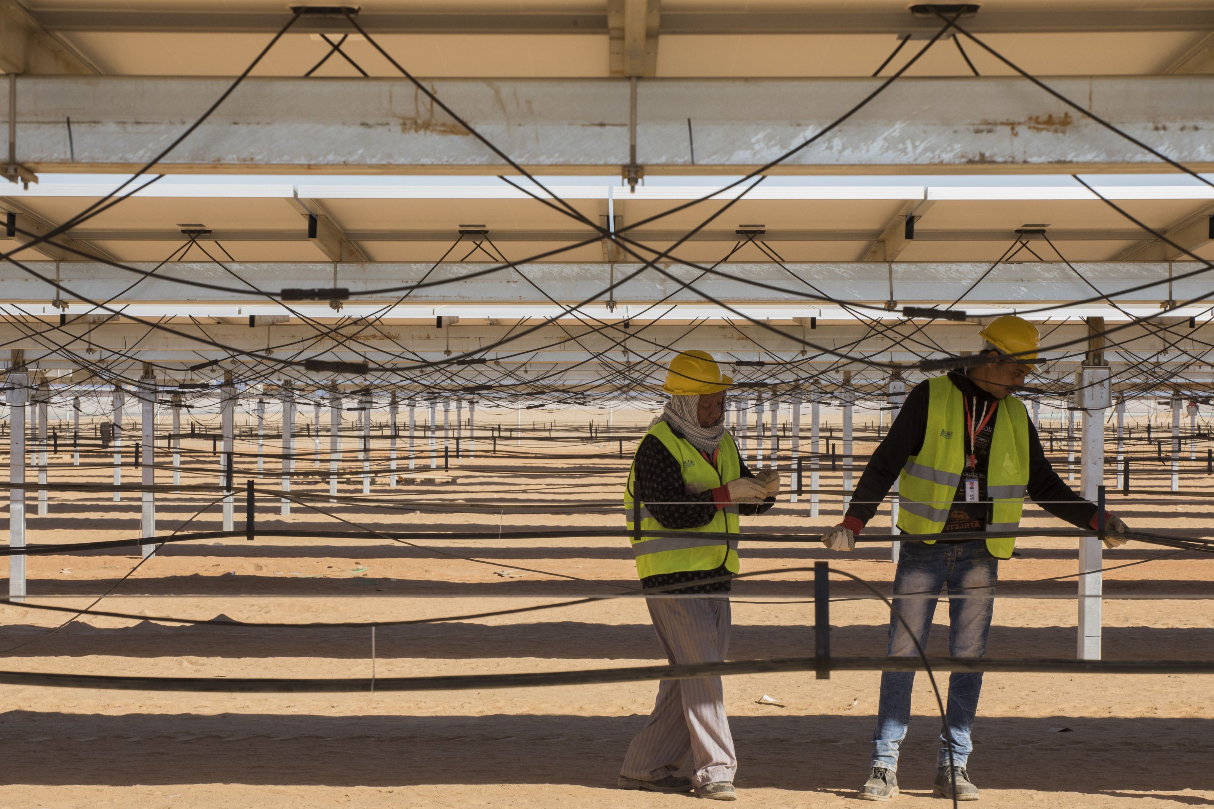 Workers at Benban photovoltaic solar park in Egypt.