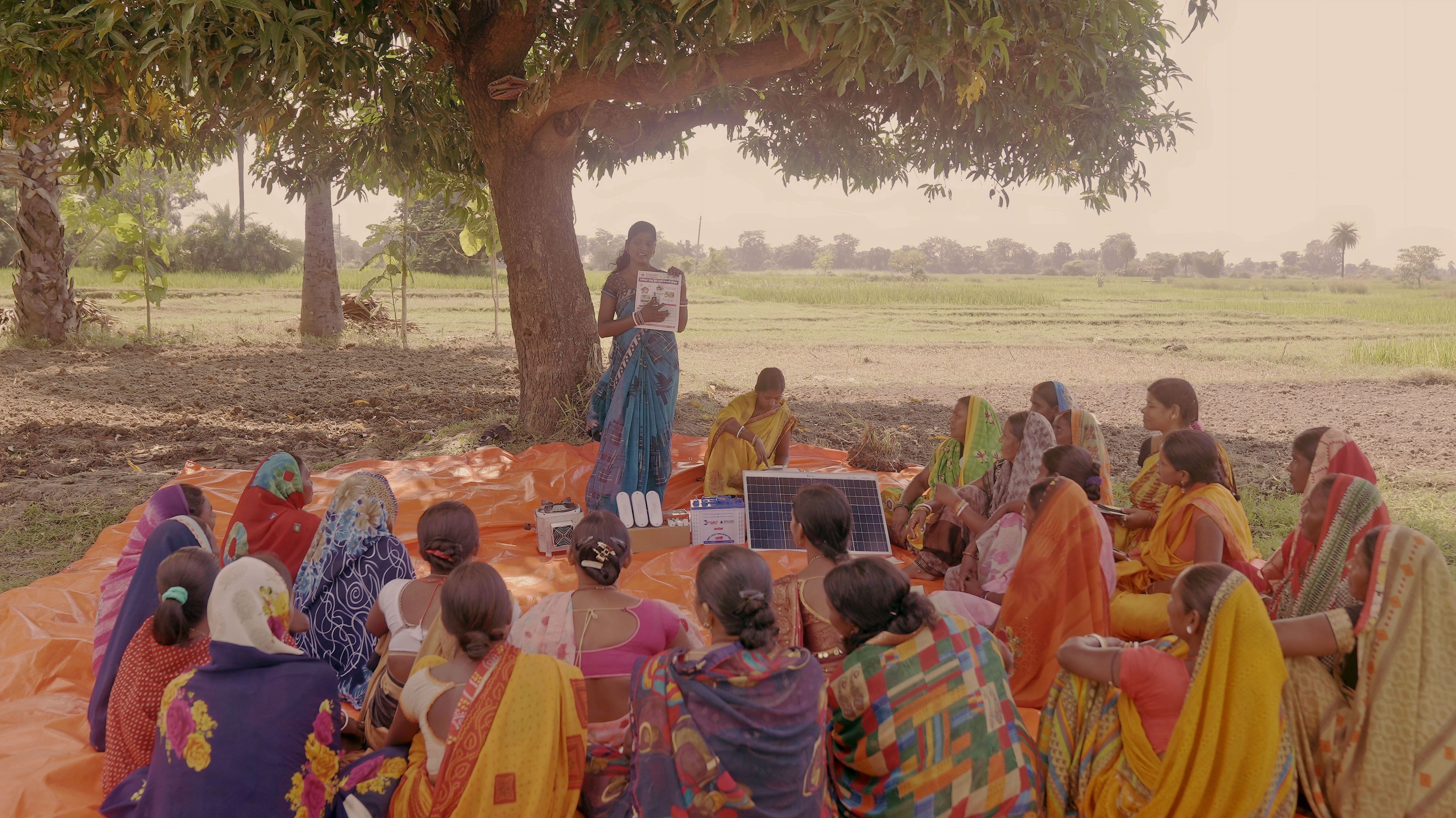 Entrepreneur Annu from Bihar, India, demonstrates clean cooking technology to a group of women
