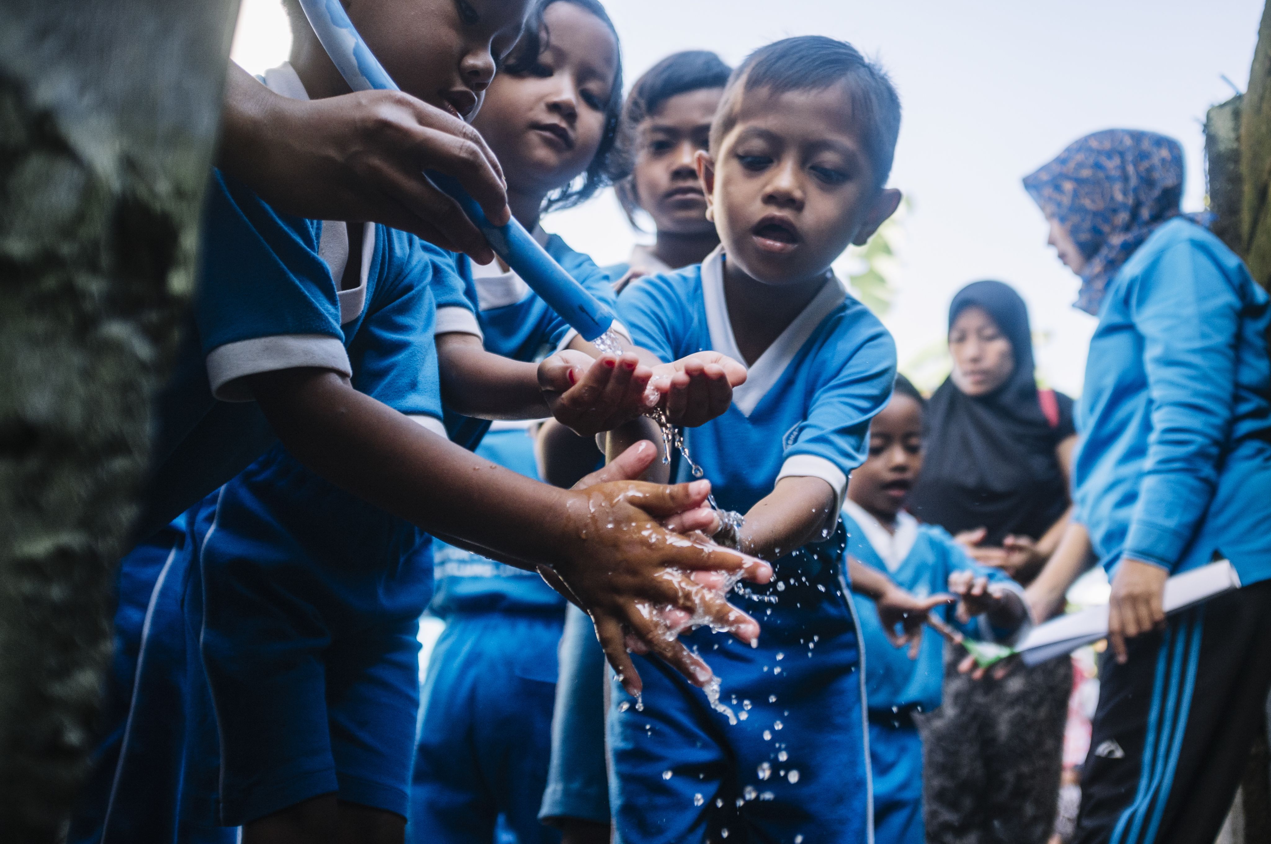 Niños lavándose las manos con agua. © Atet Dwi Pramadia/Banco Mundial