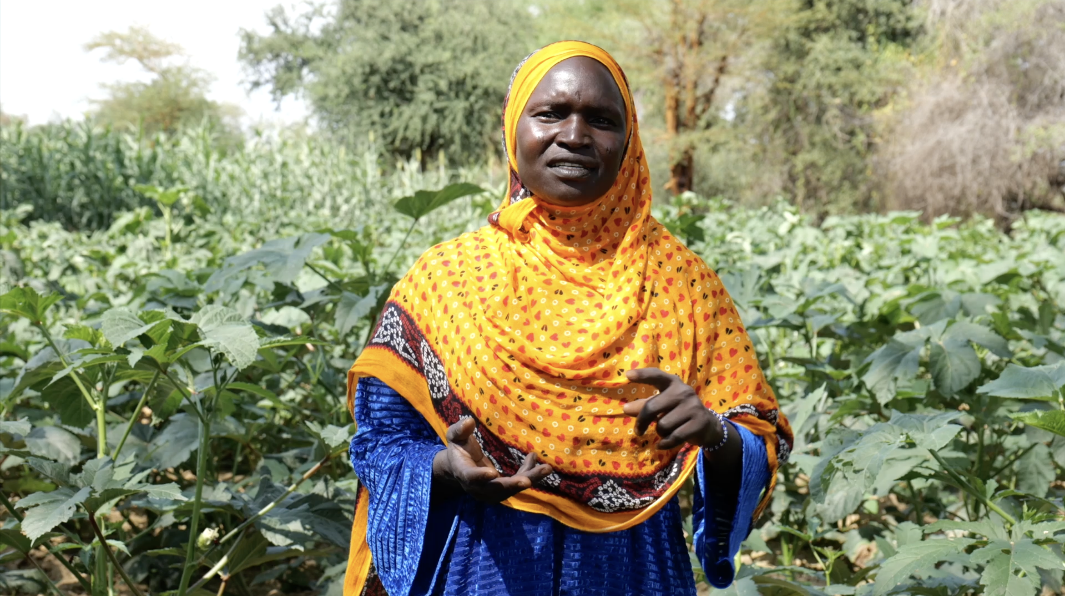 A closeup image of a female farmer in Chad in front of her horticulture field