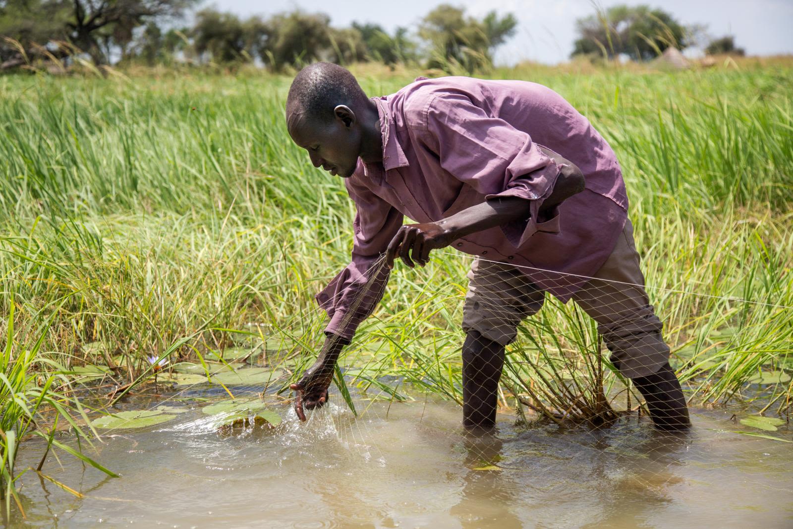 Local community member fishing on the Nile River.