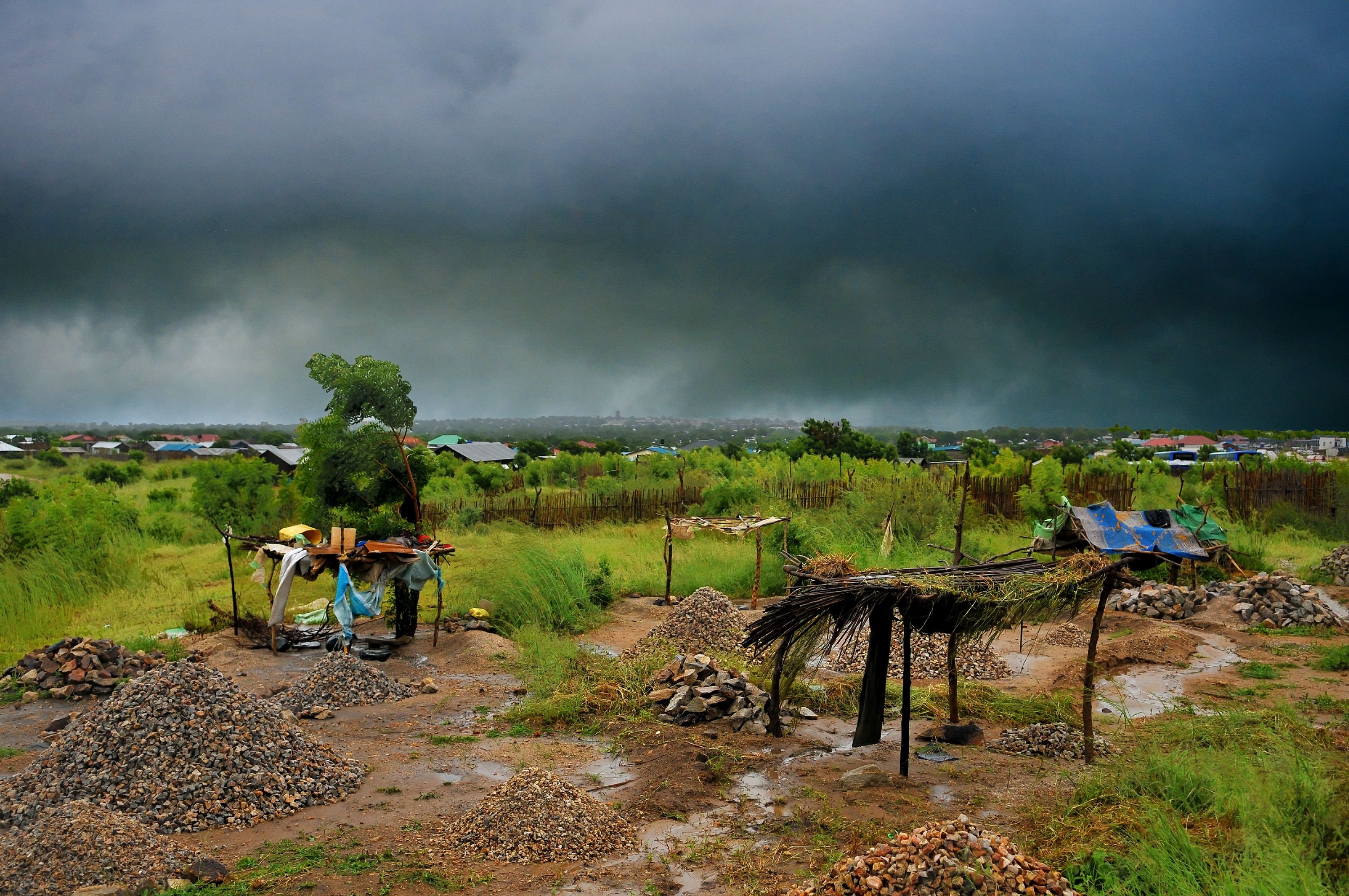 A landscape view of a rock quarry in Juba, South Sudan just before the arrival of a large cloudy storm.